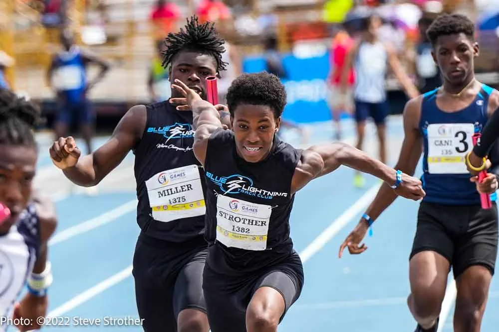 Blue Lightning 4x100 relay Champions exchanging the baton at the Junior Olympics